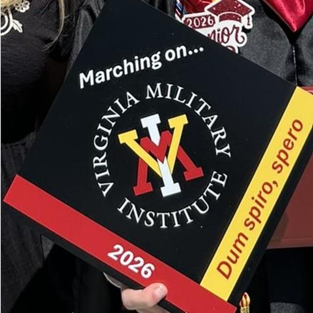 Graduate holding a Virginia Military Institute 2026 grad cap topper