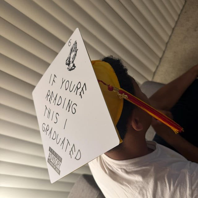 Graduate wearing an 'If You're Reading This I Graduated' grad cap topper