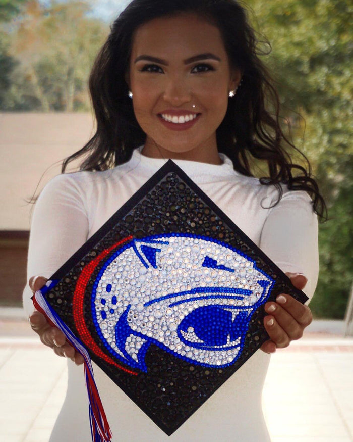 Graduate holding a rhinestone panther mascot grad cap topper