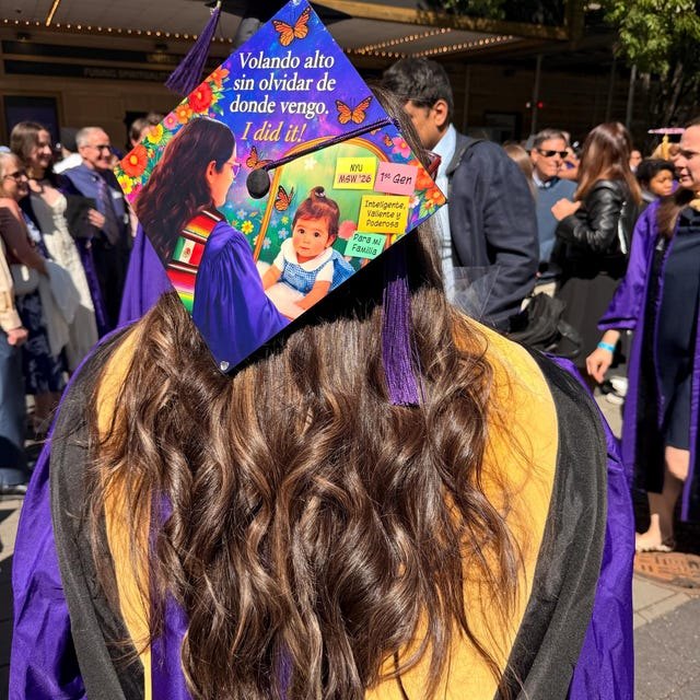 Graduate wearing a colorful photo collage 'I Did It' grad cap topper at commencement
