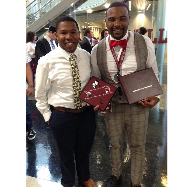Graduate holding a maroon theater masks and music notes grad cap topper beside a Mississippi State diploma