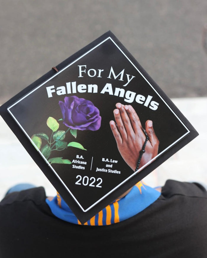 Graduate wearing a 'For My Fallen Angels 2022' memorial grad cap topper