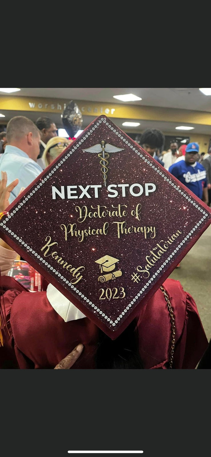Graduate wearing NEXT STOP Doctorate of Physical Therapy cap, ceremony