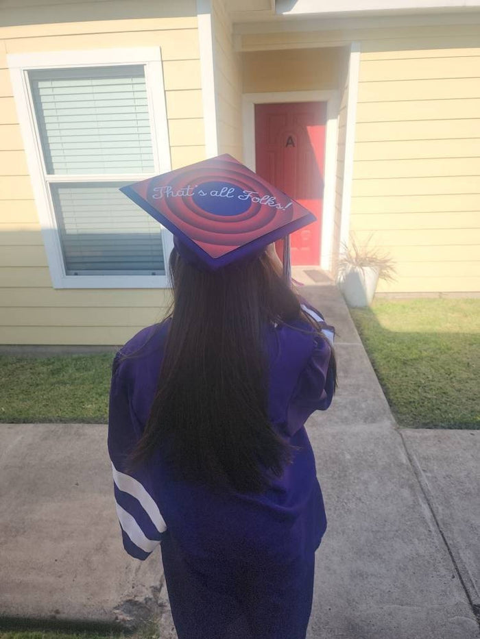 Graduate wearing cap outside house, back view