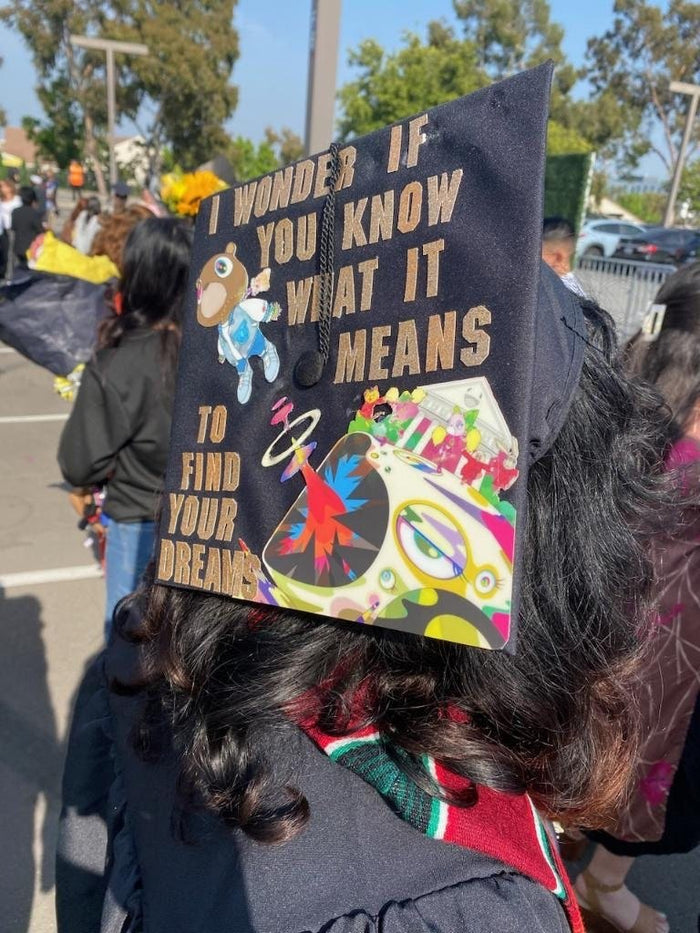 Graduate wearing Kanye I Wonder If You Know cap at ceremony