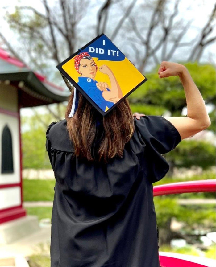 Graduate flexing wearing Rosie I Did It cap