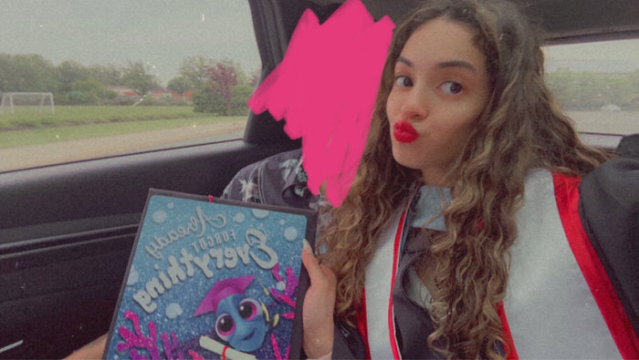 Woman in car holding Krusty Krab topper