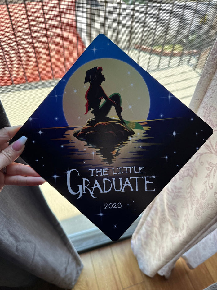Hand holding Little Mermaid The Little Graduate 2023 topper