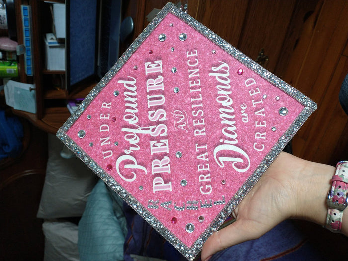 Hand holding pink Under Profound Pressure Diamonds topper
