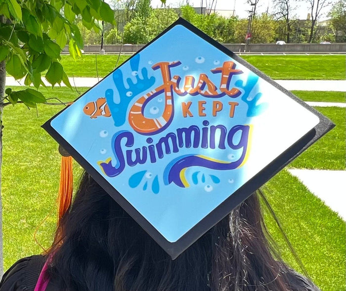Graduate wearing Just Kept Swimming Nemo cap, back view