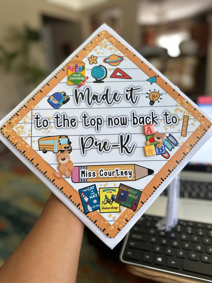 Hand holding Made It To The Top Pre-K teacher topper