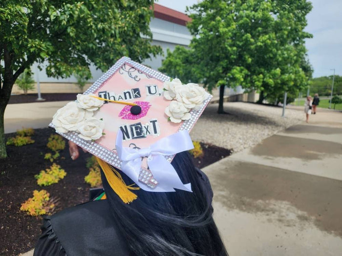 Graduate wearing Thank U Next roses cap, back view