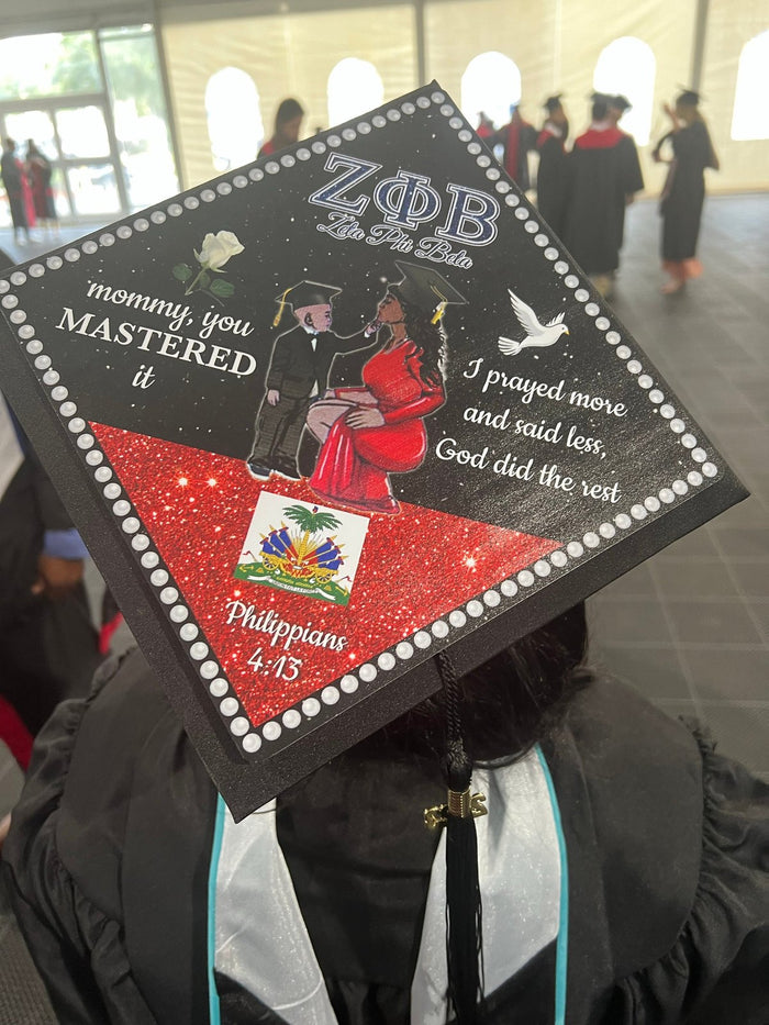Graduate wearing Zeta Phi Beta Haiti Mastered It cap at ceremony