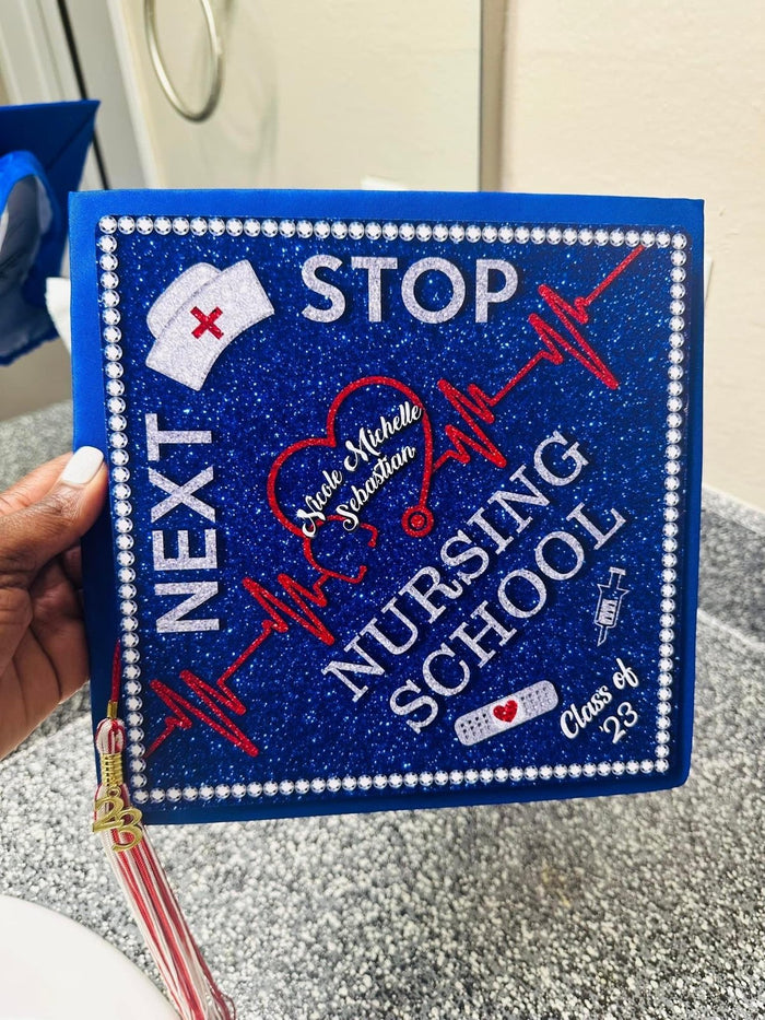 Hand holding Next Stop Nursing School blue topper