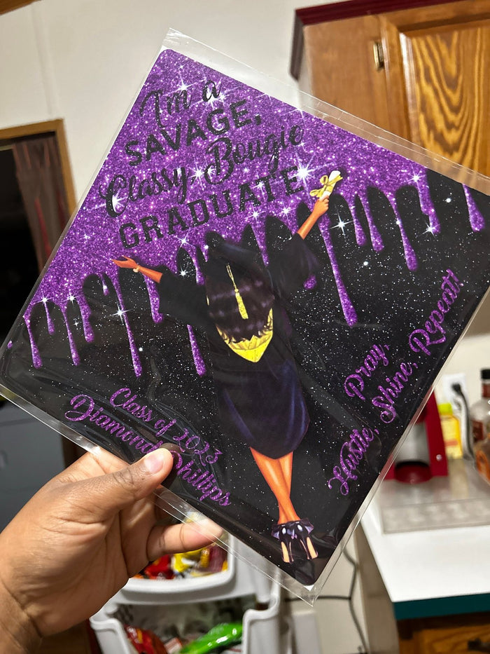 Hand holding purple Savage Classy Bougie Graduate topper in sleeve
