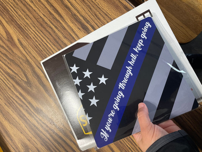 Hand holding thin blue line flag topper