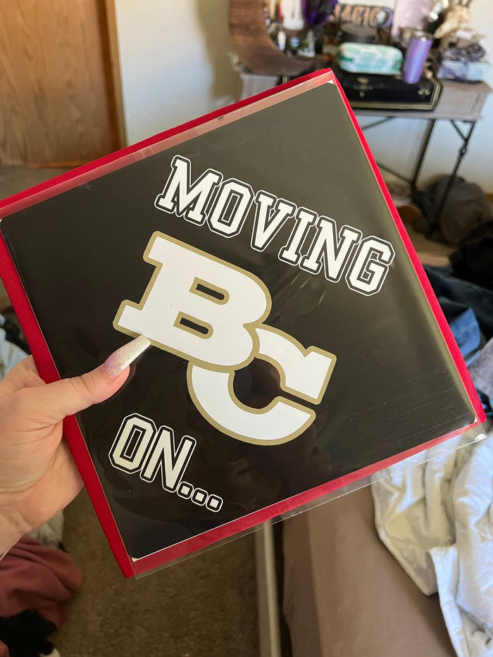 Hand holding Moving On Boston College topper