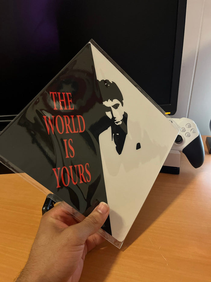 Hand holding Scarface The World Is Yours topper