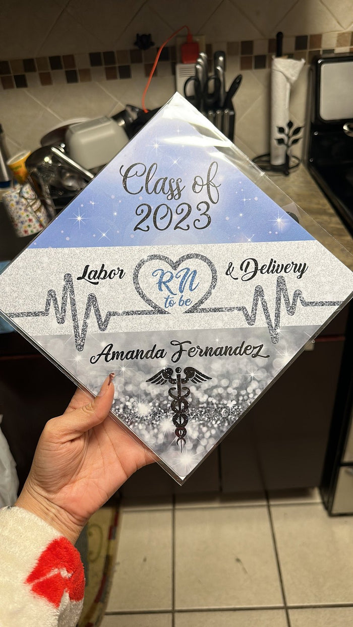 Hand holding Class of 2023 Labor and Delivery RN topper