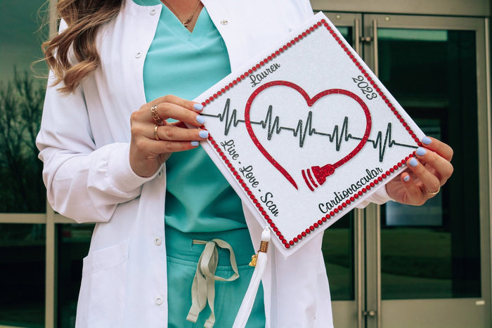 Woman in white coat holding cardiovascular heartbeat cap
