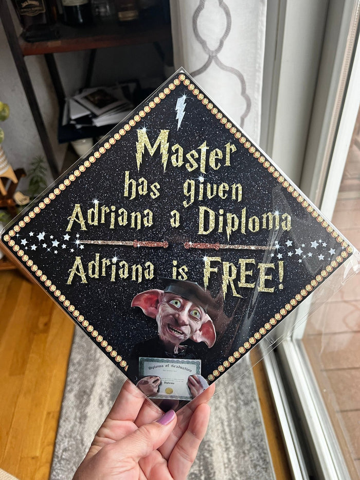 Hand holding Dobby Master Has Given Adriana A Diploma topper