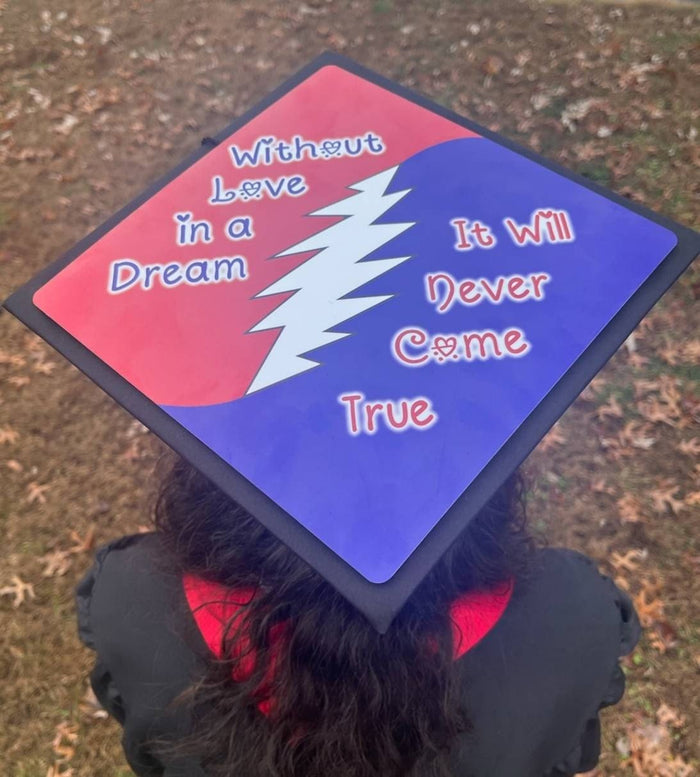 Graduate wearing Grateful Dead Without Love In A Dream cap