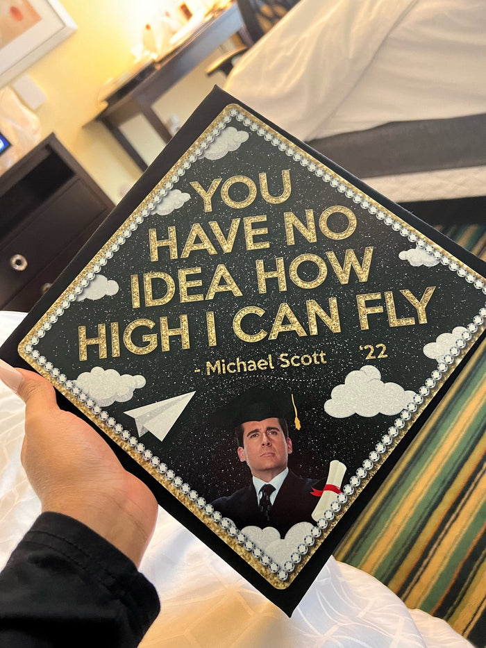 Hand holding Michael Scott How High I Can Fly topper
