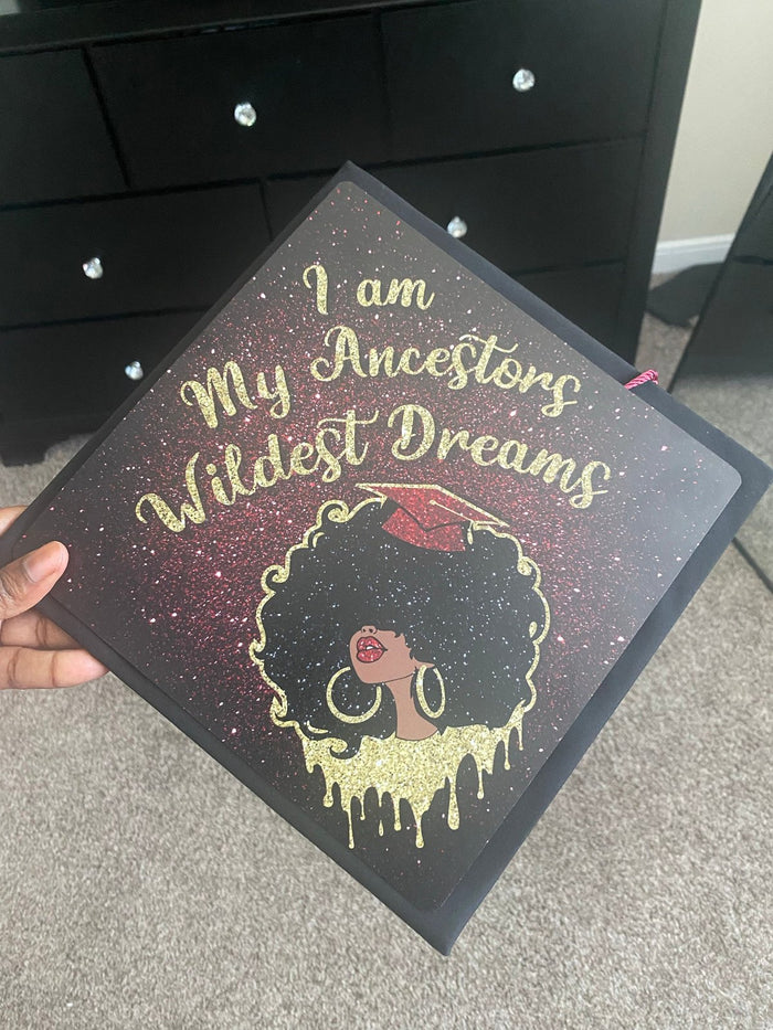 Hand holding I Am My Ancestors Wildest Dreams topper