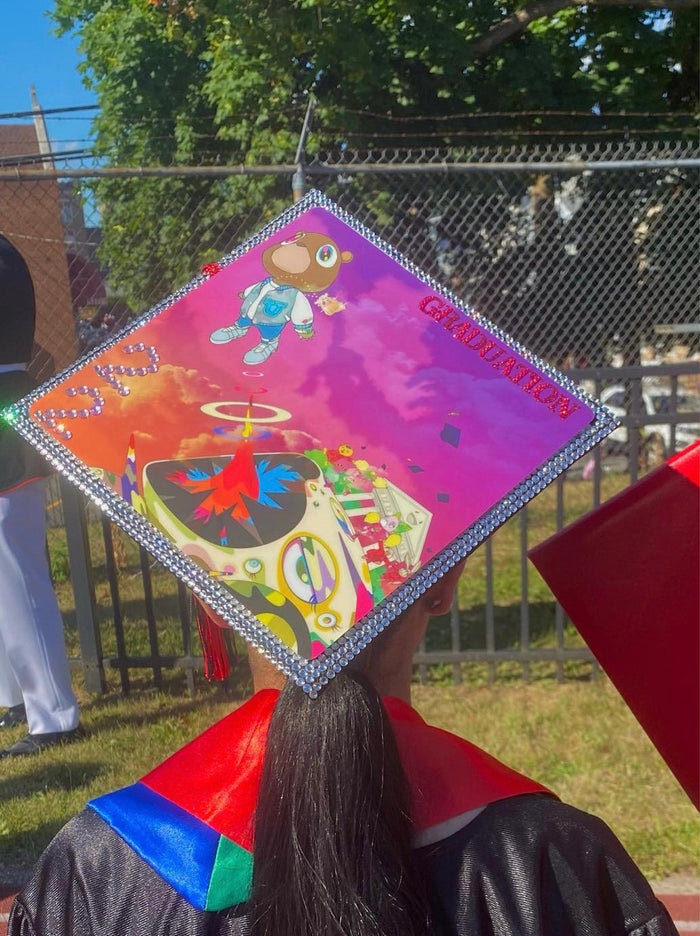 Graduate wearing Kanye cap outdoors, back view
