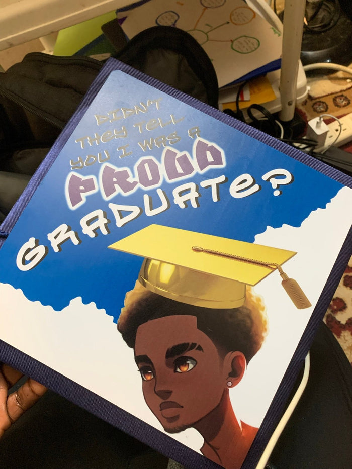 Hand holding Proud Family Proud Graduate cap