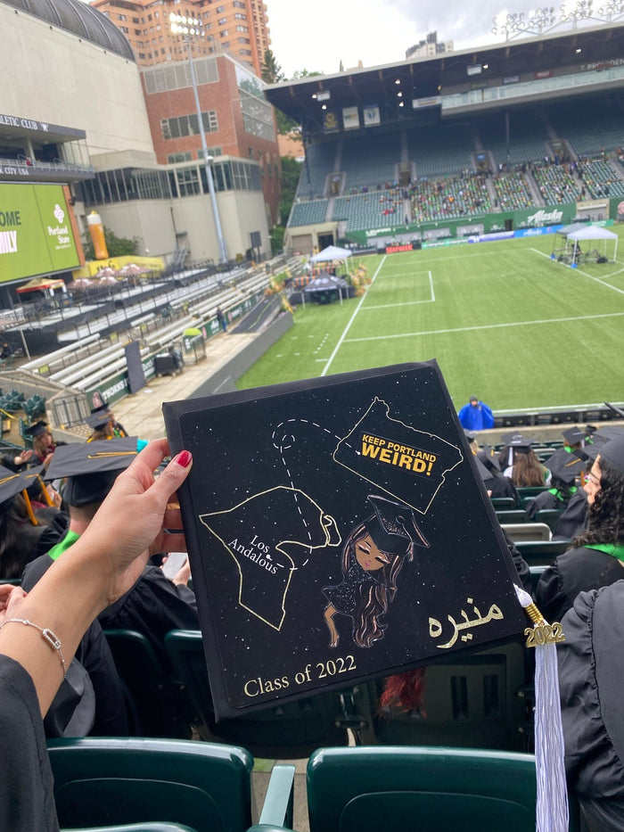 Hand holding Class of 2022 cap at stadium