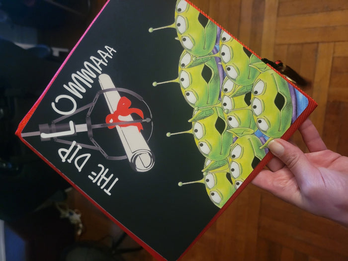 Hand holding Toy Story aliens The Diplowmaaa topper