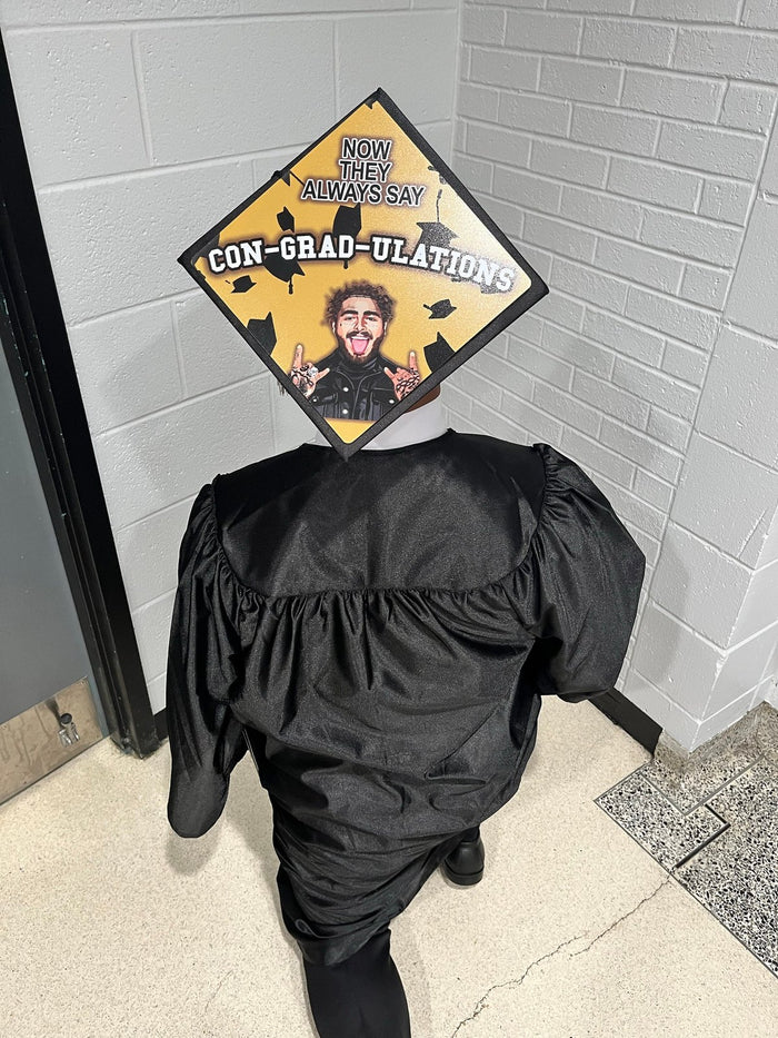 Graduate wearing Post Malone Con-grad-ulations cap, back view