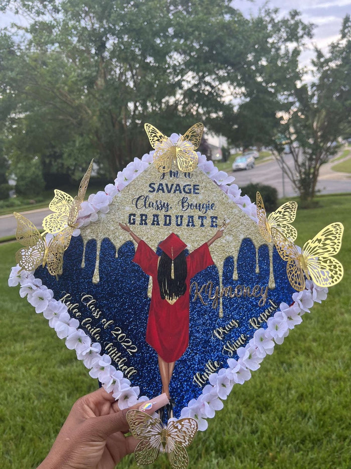 Hand holding blue Savage Classy Bougie butterfly topper