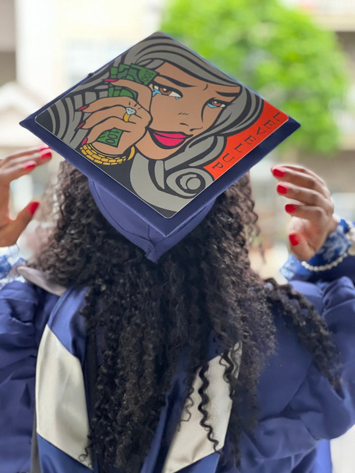 Graduate wearing illustrated woman money cap, back view