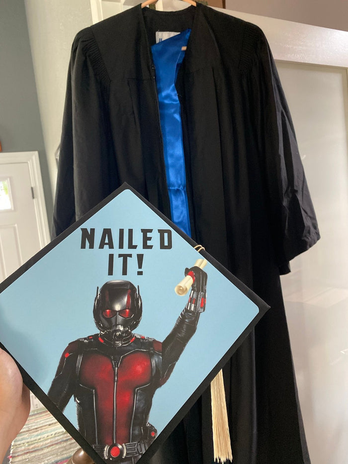 Hand holding Ant-Man Nailed It topper