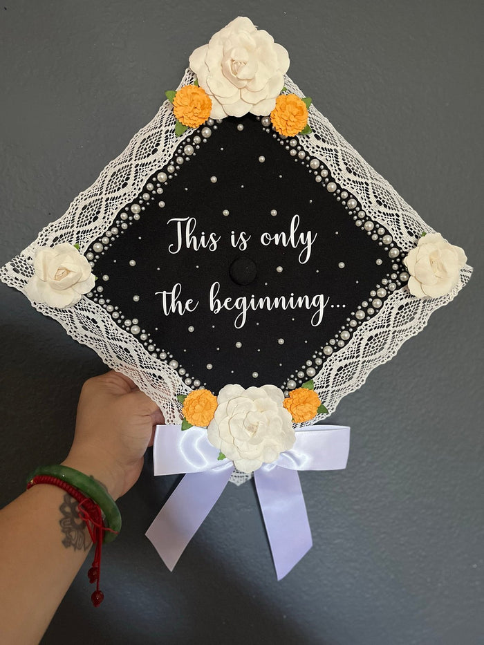 Hand holding This Is Only The Beginning lace cap