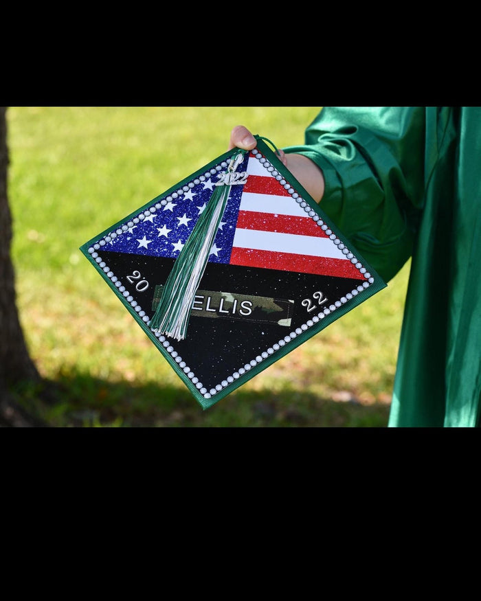 Hand holding US flag Ellis 2022 cap