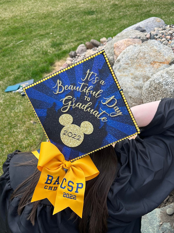 Graduate wearing Its A Beautiful Day To Graduate Mickey cap