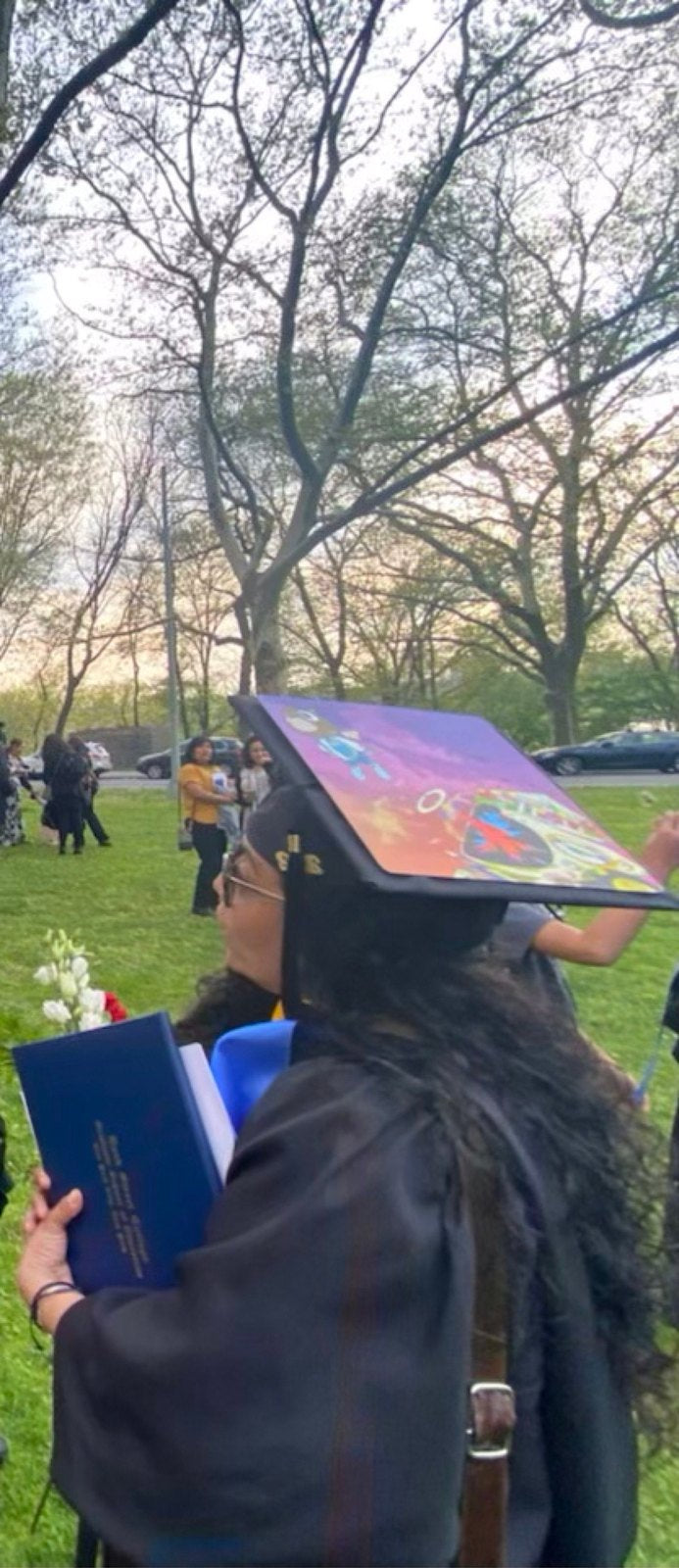 Graduate wearing colorful cap in park