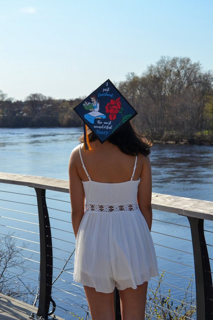 Woman wearing Belle Most Wonderful Story cap by river