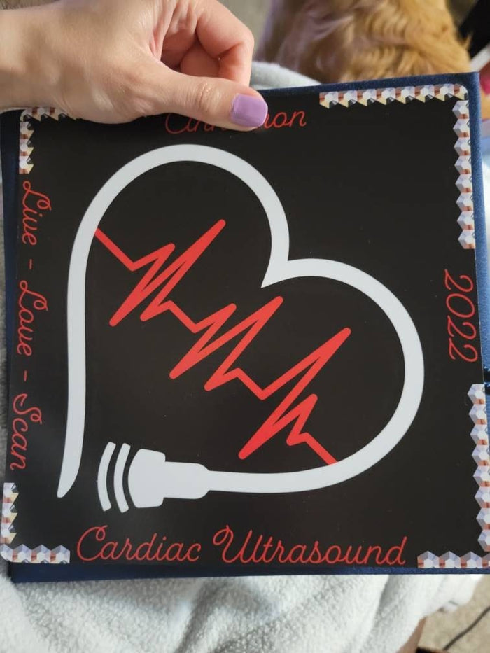 Hand holding Cardiac Ultrasound heart topper