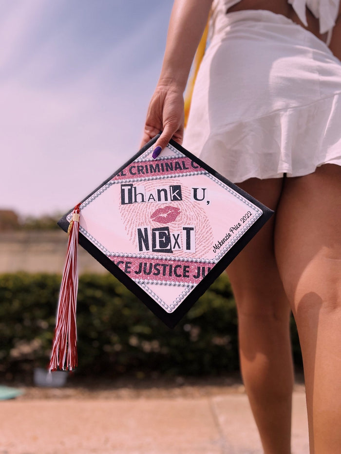 Woman holding Thank U Next criminal justice cap