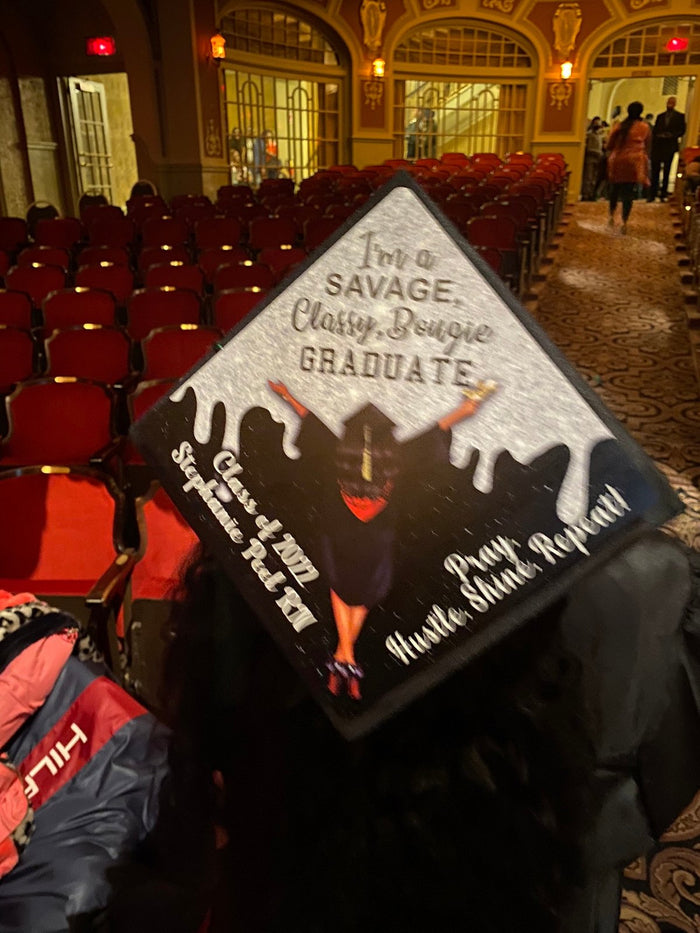 Graduate wearing Savage Classy Bougie cap in auditorium
