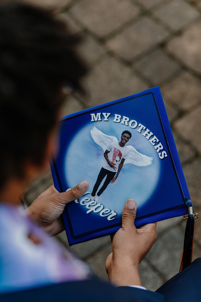 Person holding My Brothers Keeper angel photo topper