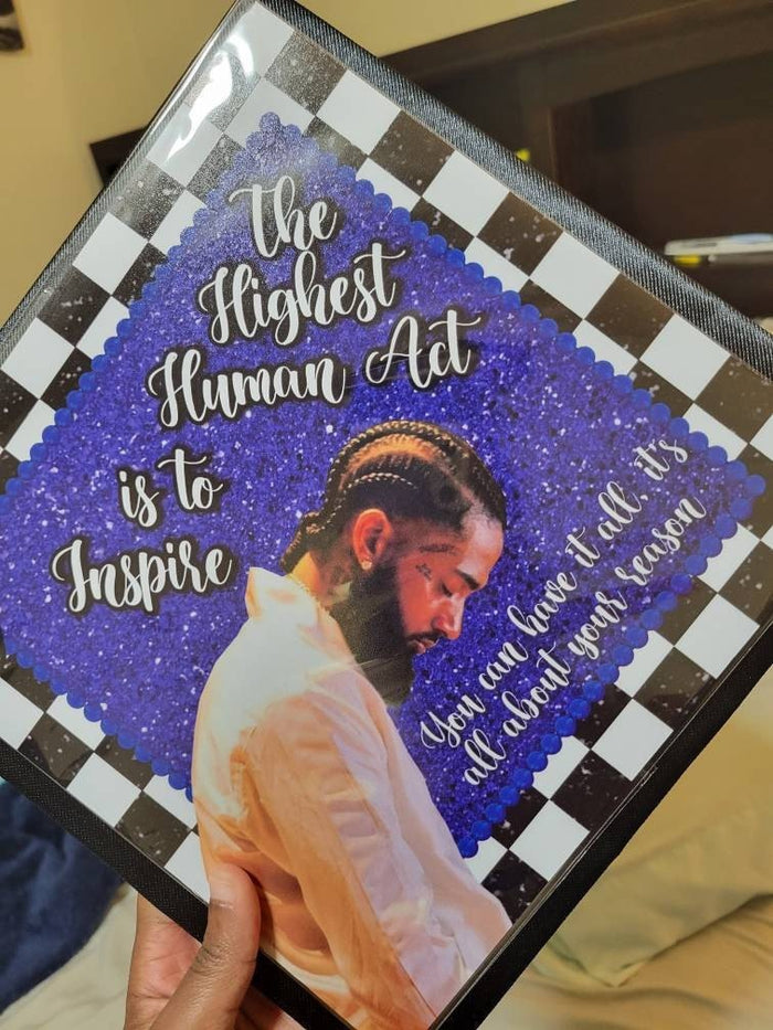 Hand holding Nipsey Hussle Highest Human Act topper