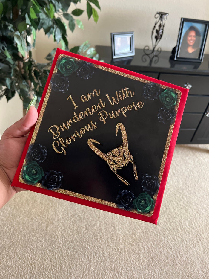 Hand holding Loki Burdened With Glorious Purpose topper