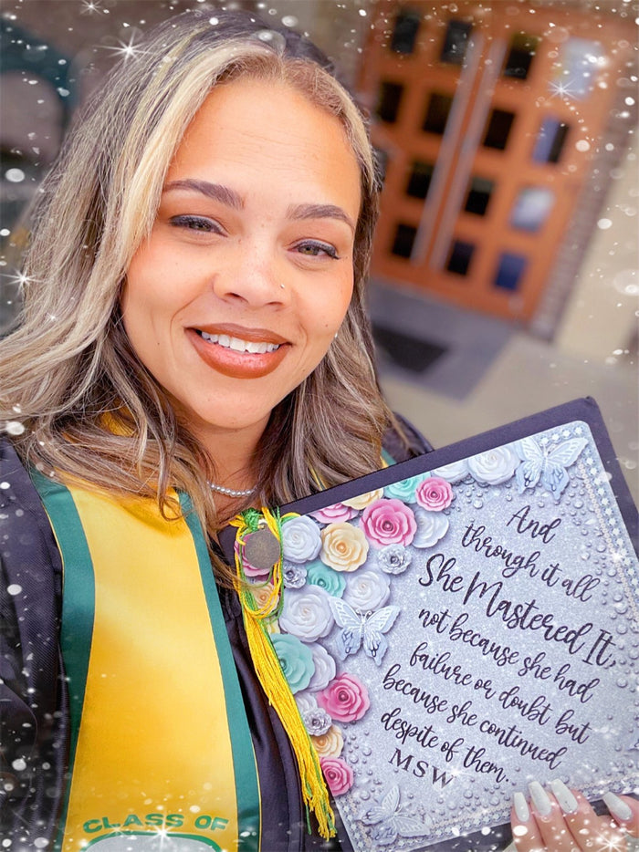 Graduate selfie holding She Mastered It MSW topper