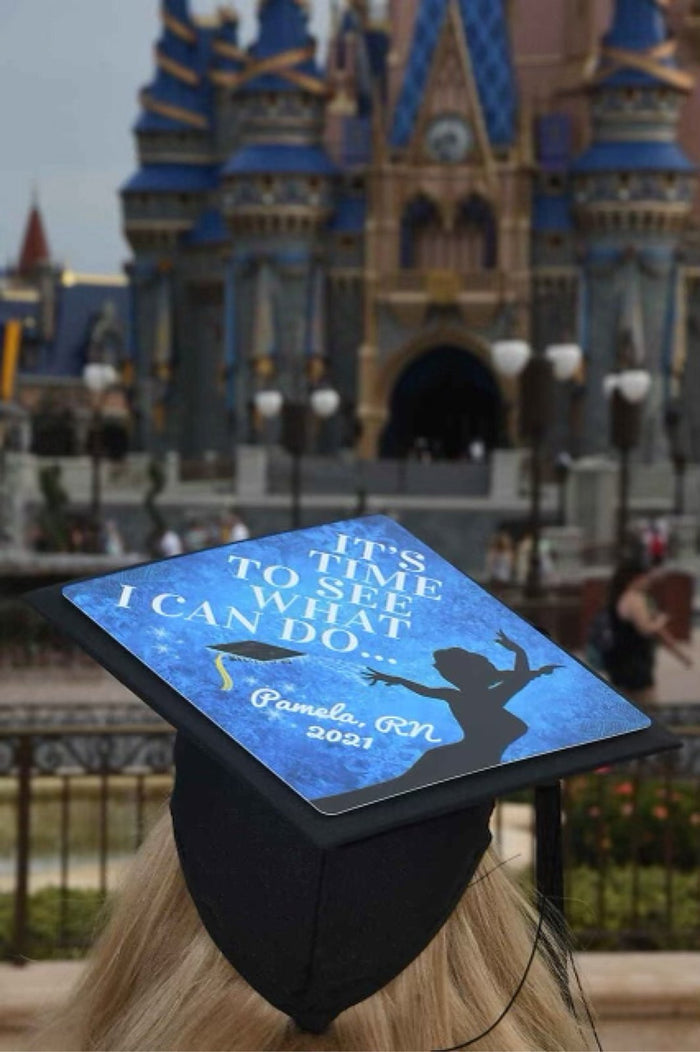 Graduate wearing Tiana Its Time cap at Disney castle