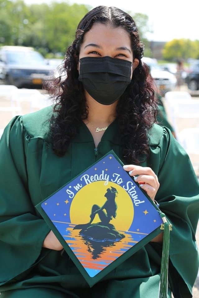 Graduate holding Cowboy Bebop Ready To Stand cap